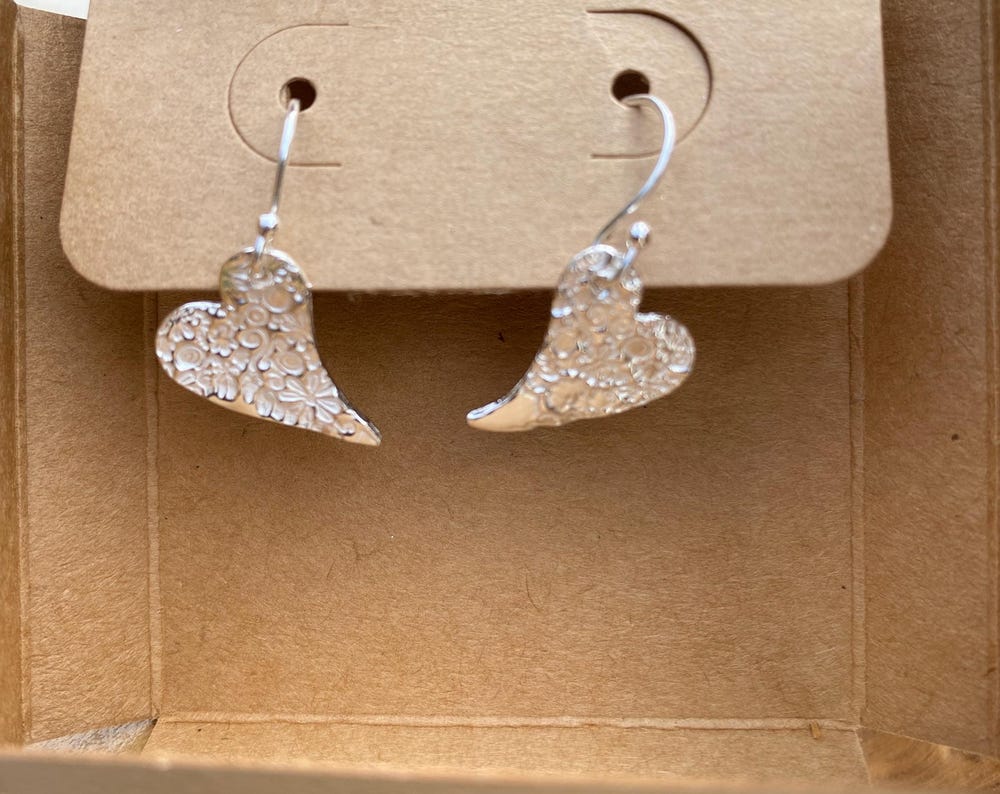 Fine silver flower print heart drop earrings, handmade in Gloucestershire, UK.